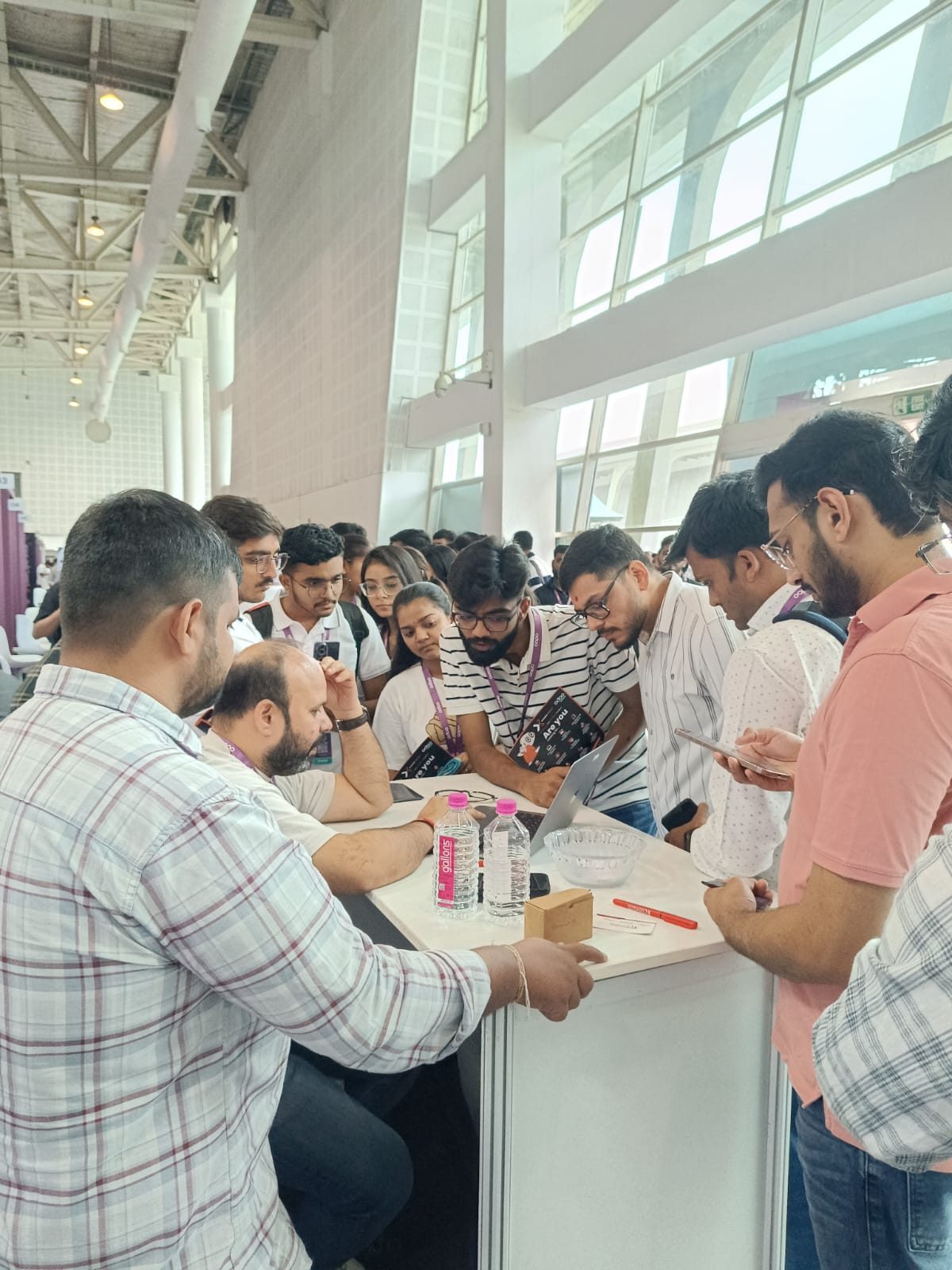 Cluster of visitors around the Redian booth working through a live Odoo BFSI workflow demo